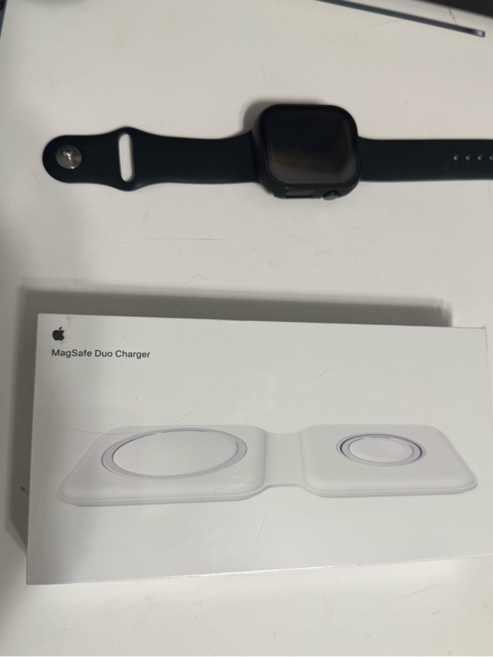 Apple MagSafe Duo Charger in white with black Apple Watch shown